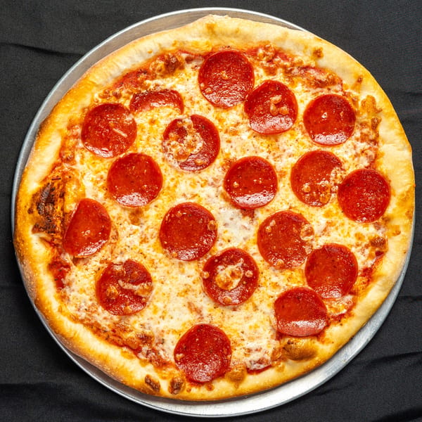 A whole pepperoni pizza from Napoli's Pizza & Restaurant, on a metal pan against a dark background.
